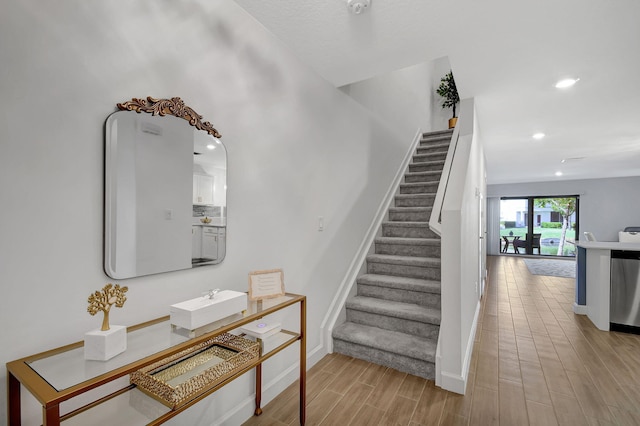 stairway with hardwood / wood-style floors