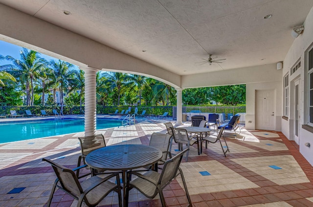 view of patio featuring ceiling fan and a community pool