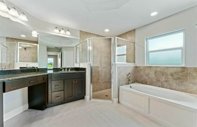 bathroom with vanity and independent shower and bath