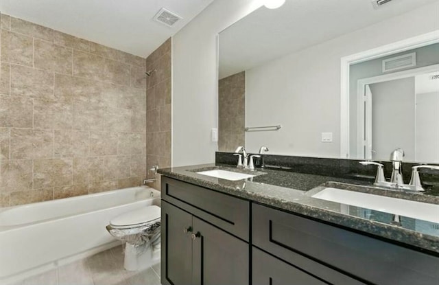 full bathroom with tile patterned floors, tiled shower / bath combo, toilet, and vanity