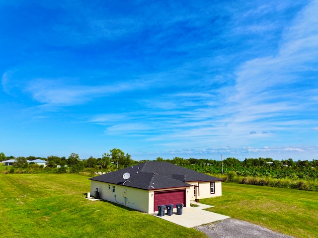 exterior space with a yard and a garage