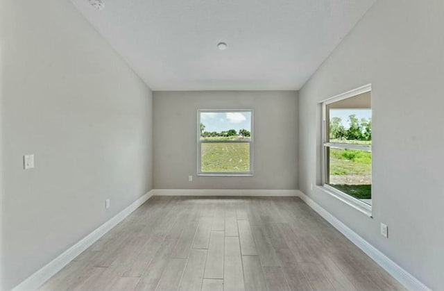 empty room with light hardwood / wood-style flooring