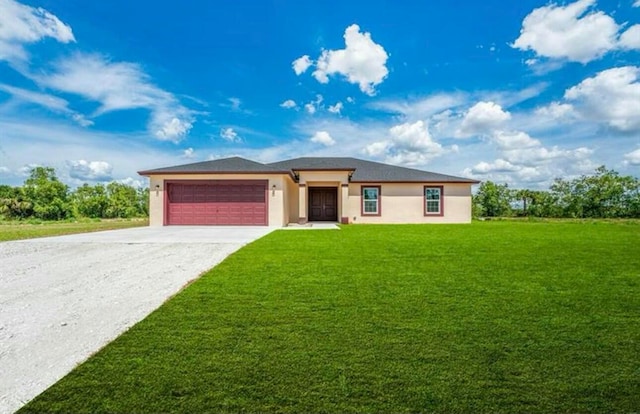 view of front of home featuring a front yard and a garage