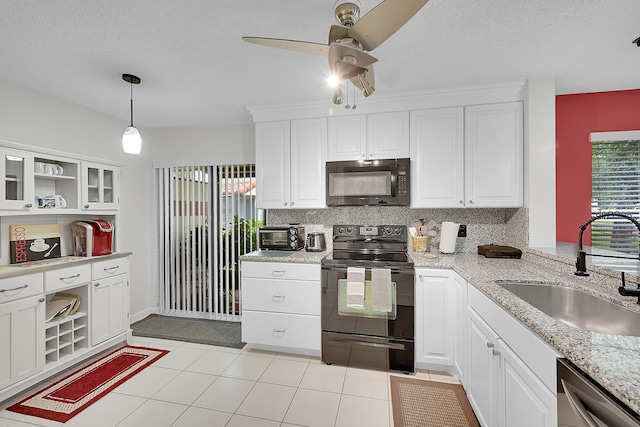 kitchen featuring sink, white cabinets, and black appliances