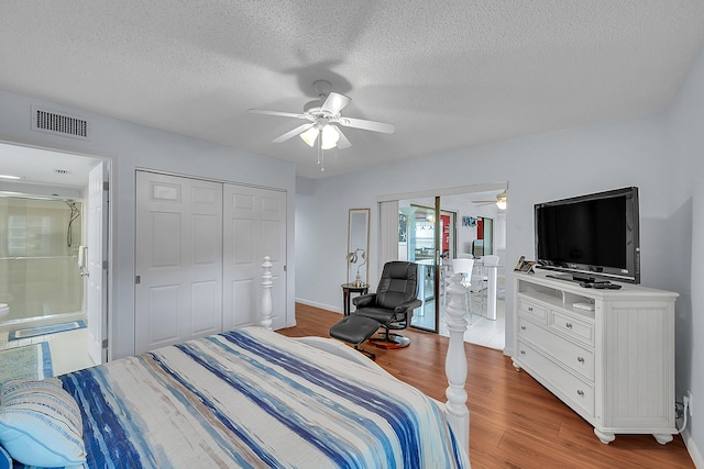 bedroom featuring hardwood / wood-style flooring, a textured ceiling, and ceiling fan