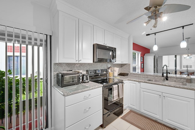 kitchen with sink, backsplash, light stone counters, black appliances, and white cabinets