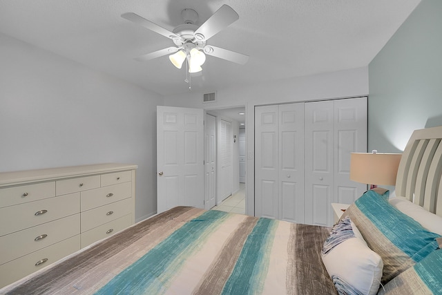 bedroom featuring a closet, ceiling fan, and light tile patterned flooring