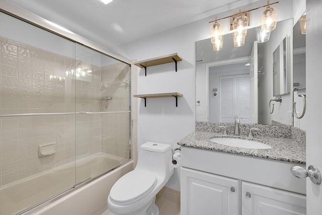 full bathroom with bath / shower combo with glass door, vanity, and toilet