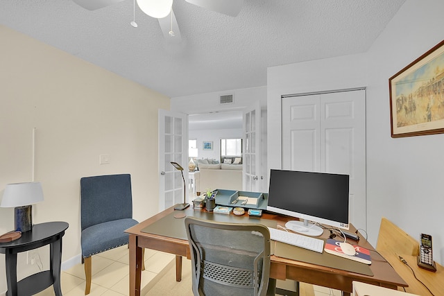 home office featuring ceiling fan, a textured ceiling, and french doors