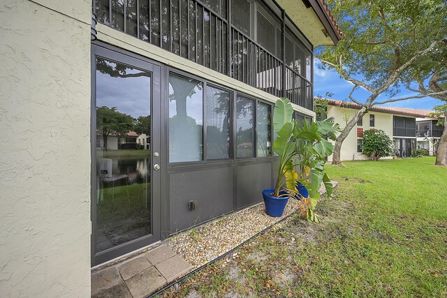 doorway to property featuring a yard