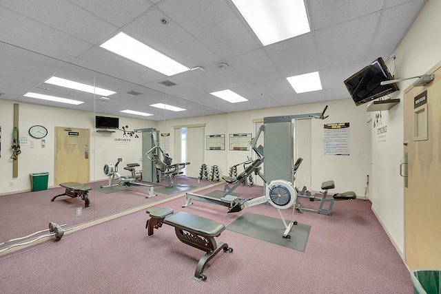 exercise room with a paneled ceiling