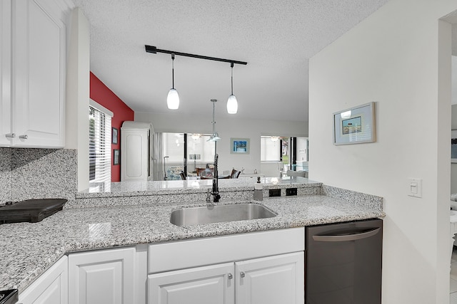 kitchen with pendant lighting, black dishwasher, sink, and white cabinets