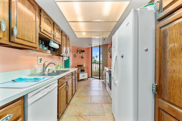 kitchen featuring white appliances and sink