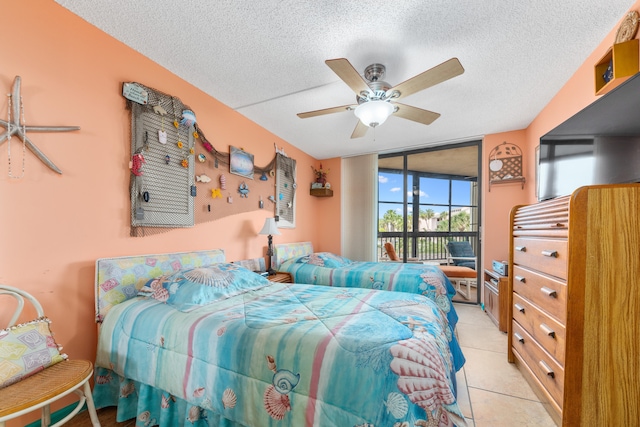 bedroom featuring a textured ceiling, access to outside, ceiling fan, and light tile patterned flooring