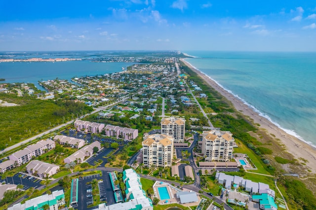 drone / aerial view featuring a water view and a beach view