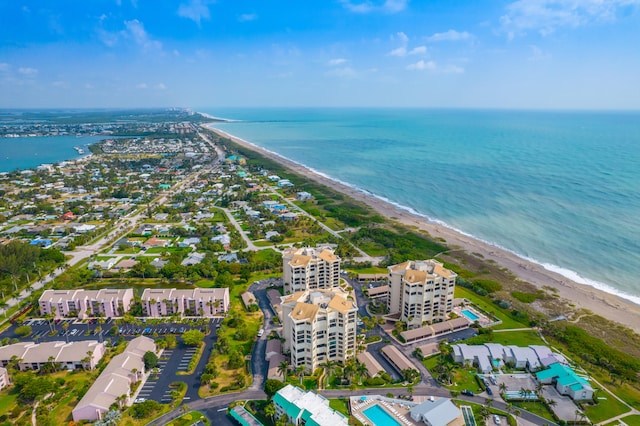 birds eye view of property featuring a beach view and a water view