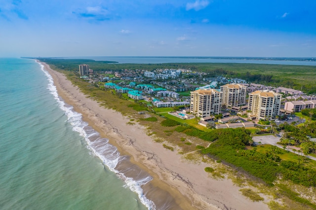 bird's eye view with a water view and a beach view