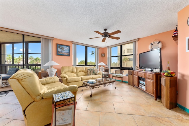 tiled living room with a textured ceiling, expansive windows, and ceiling fan