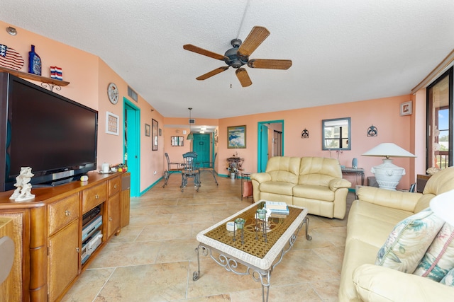 living room with a textured ceiling and ceiling fan