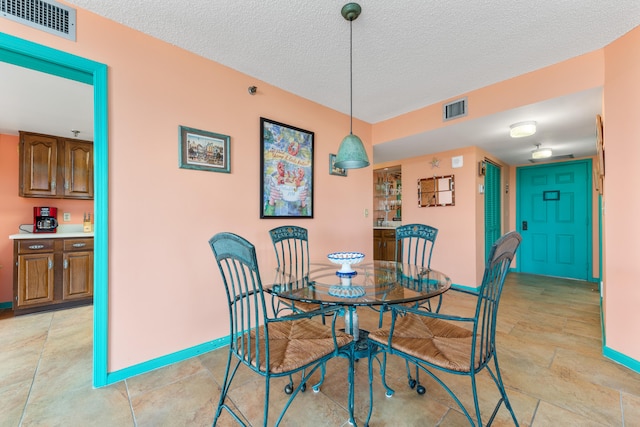 dining room with a textured ceiling