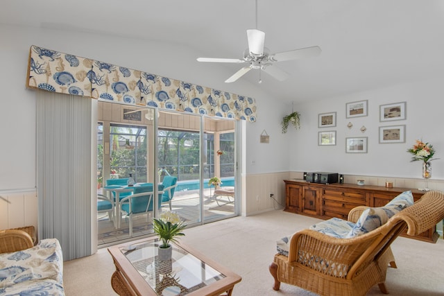 living room with light carpet, ceiling fan, and lofted ceiling