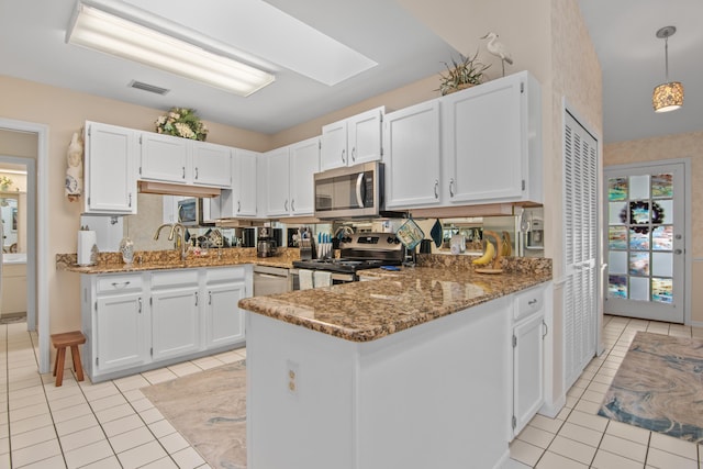 kitchen featuring kitchen peninsula, white cabinets, and stainless steel appliances