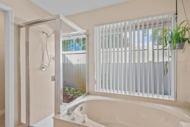 bathroom featuring separate shower and tub