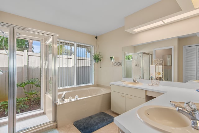 bathroom featuring tile patterned floors, plus walk in shower, and vanity