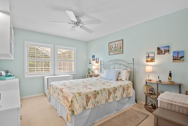 bedroom with ceiling fan and light carpet