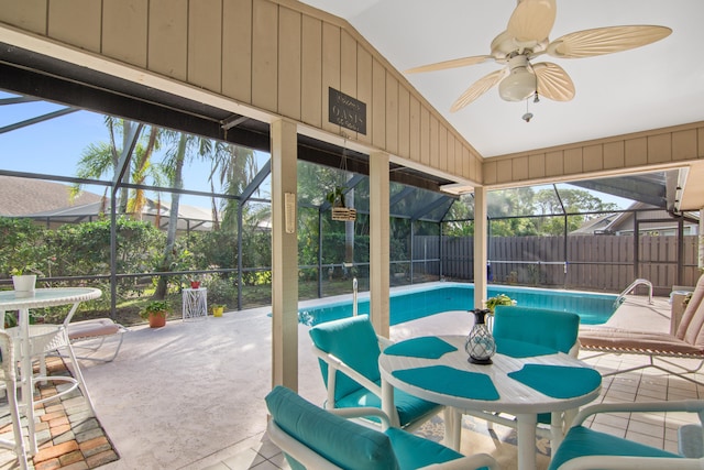 sunroom / solarium featuring ceiling fan and vaulted ceiling