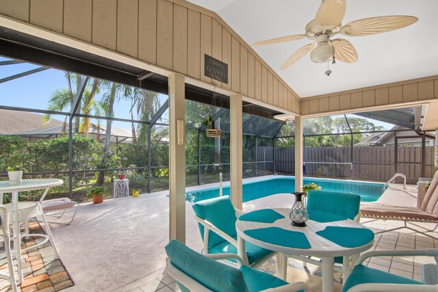 view of pool featuring a lanai, ceiling fan, and a patio area