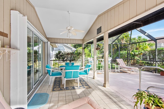 sunroom / solarium featuring a wealth of natural light, ceiling fan, and vaulted ceiling