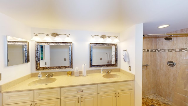 bathroom with vanity and tiled shower