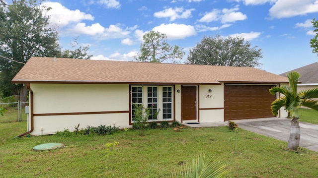 single story home featuring a garage and a front lawn