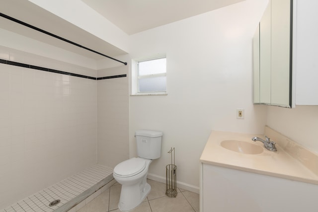 bathroom with vanity, a tile shower, tile patterned floors, and toilet