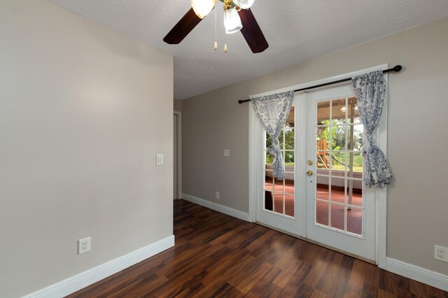 unfurnished room featuring ceiling fan, dark wood-type flooring, a textured ceiling, and french doors