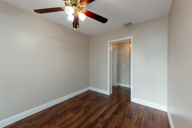 unfurnished room with dark hardwood / wood-style flooring, ceiling fan, and a textured ceiling