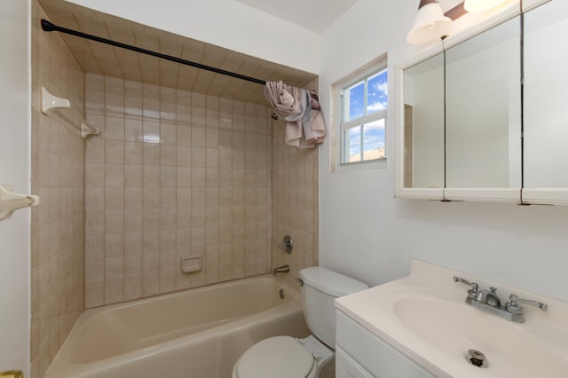 full bathroom featuring tiled shower / bath combo, vanity, and toilet