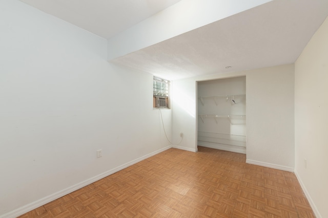 unfurnished room featuring cooling unit and light parquet floors