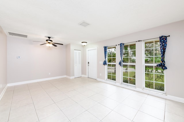 tiled spare room featuring ceiling fan and a textured ceiling