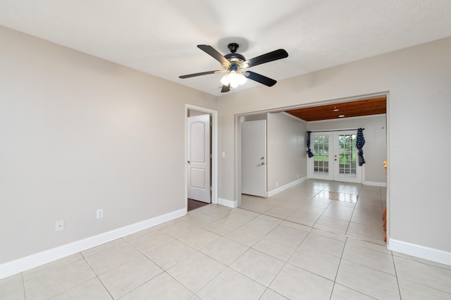 tiled empty room with french doors and ceiling fan