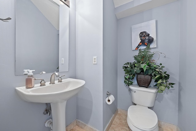 bathroom with tile patterned flooring and toilet