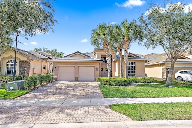 ranch-style house with a front yard and a garage