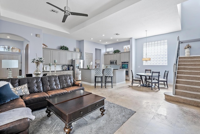 living room with ceiling fan and sink