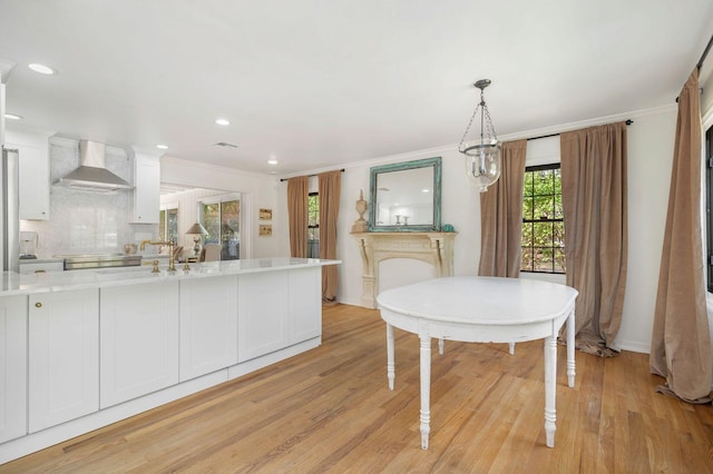 dining room with a chandelier, light hardwood / wood-style flooring, and ornamental molding