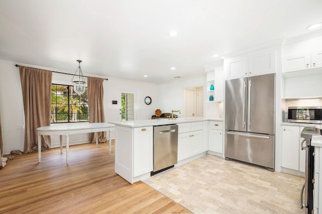 kitchen featuring white cabinetry, stainless steel appliances, light hardwood / wood-style flooring, kitchen peninsula, and decorative light fixtures