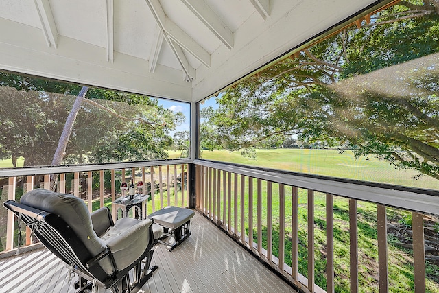 wooden terrace with a lawn