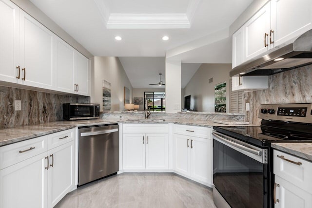 kitchen with decorative backsplash, light stone countertops, white cabinets, and appliances with stainless steel finishes