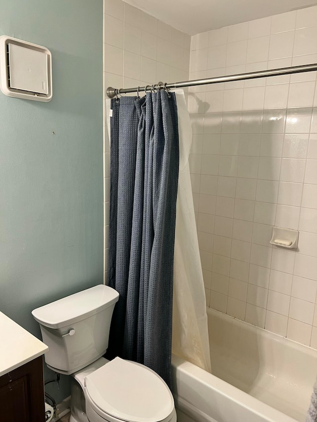 full bathroom featuring vanity, toilet, and shower / tub combo with curtain