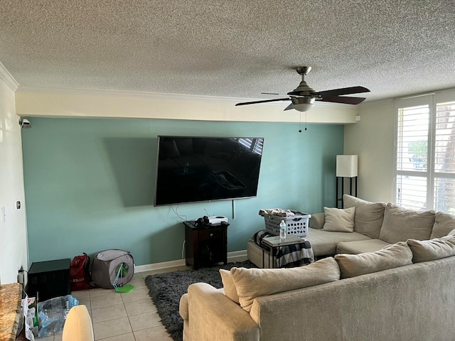 living room with ceiling fan, light tile patterned floors, and a textured ceiling